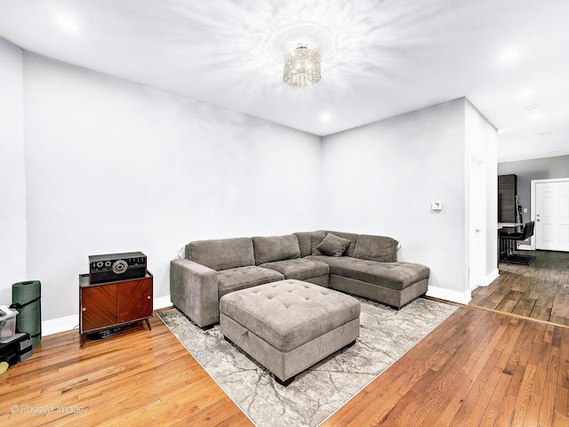 living area with baseboards and wood-type flooring