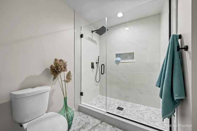 bathroom with toilet, recessed lighting, and a stall shower