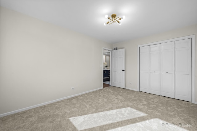 unfurnished bedroom featuring carpet flooring, visible vents, baseboards, and a closet