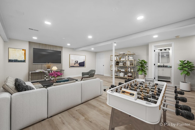 living area featuring recessed lighting, light wood-style floors, visible vents, and baseboards