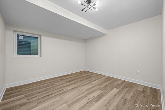 unfurnished room with wood finished floors and baseboards