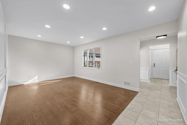 unfurnished room with light tile patterned floors, visible vents, and recessed lighting