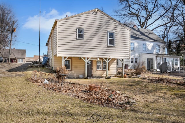 back of property featuring a lawn