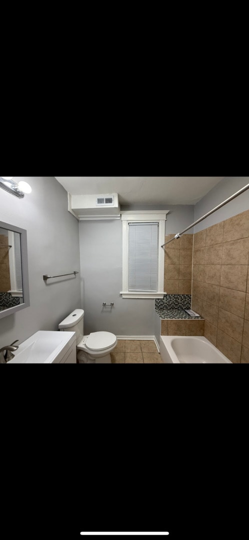 bathroom featuring visible vents, toilet, and tile patterned flooring