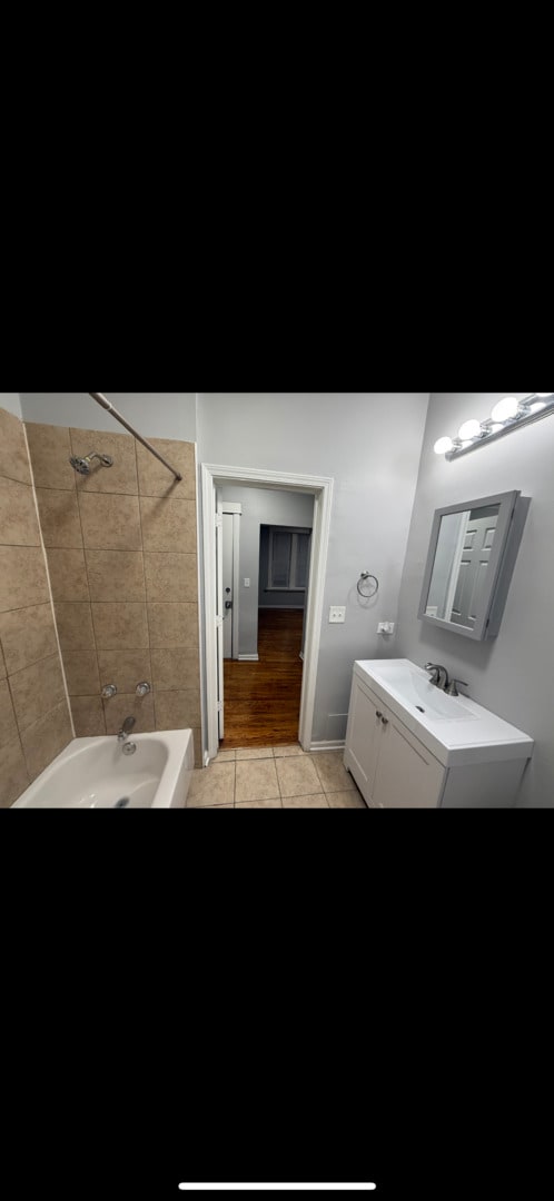 bathroom featuring vanity, tile patterned floors, and shower / tub combination