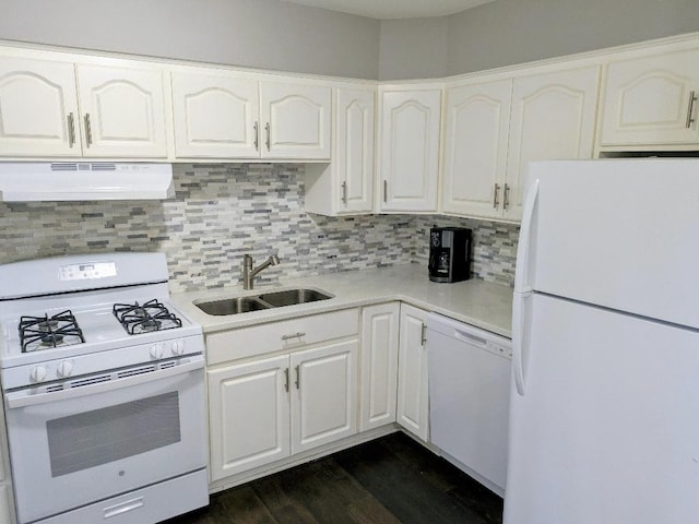 kitchen with a sink, white appliances, light countertops, decorative backsplash, and under cabinet range hood