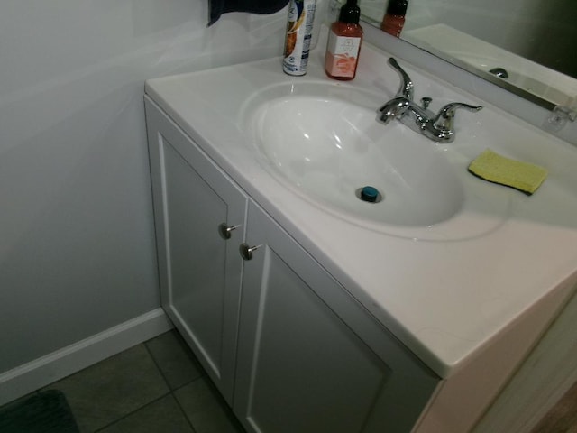 bathroom featuring vanity, baseboards, and tile patterned floors