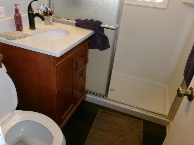 full bathroom with vanity, toilet, and a stall shower