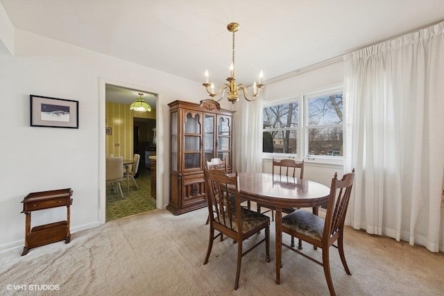 dining room with light carpet, baseboards, and an inviting chandelier