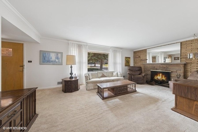 living area with a stone fireplace, light colored carpet, baseboards, and ornamental molding