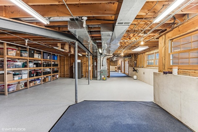 basement with heating unit and visible vents