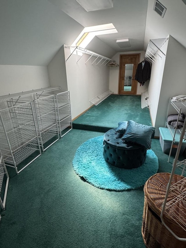 bonus room with visible vents, vaulted ceiling with skylight, and carpet