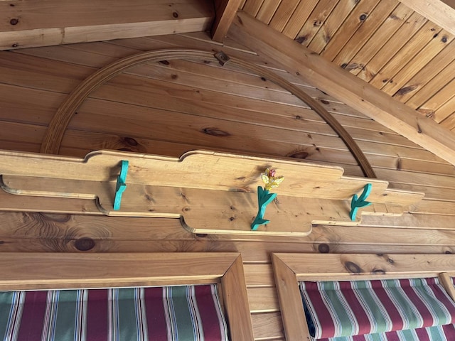 room details with wooden ceiling, wooden walls, and beam ceiling