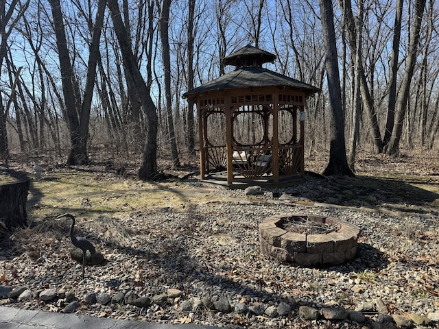 view of yard featuring a gazebo and an outdoor fire pit