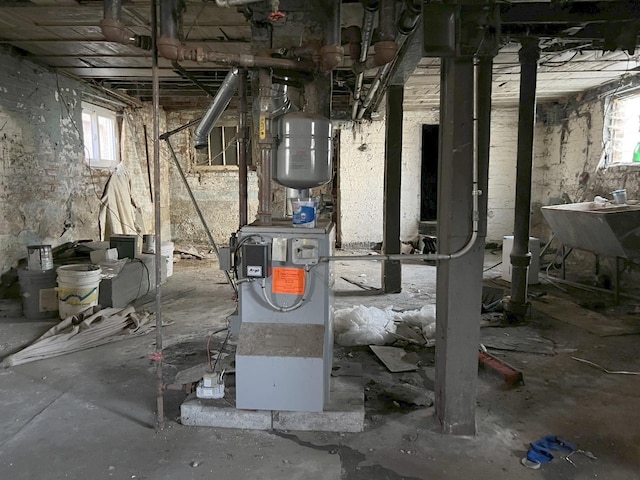 utility room with a heating unit and a sink