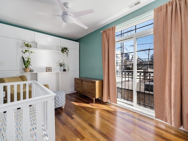 bedroom with visible vents and wood finished floors