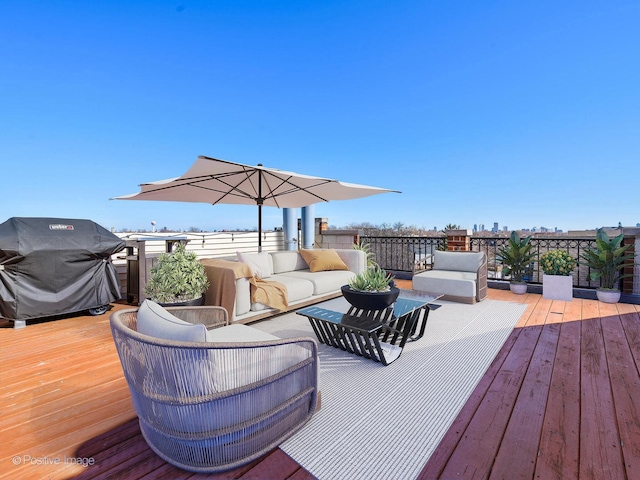 deck with an outdoor living space and a grill