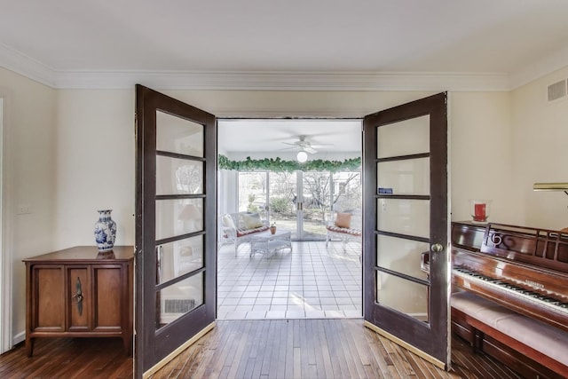 entryway featuring visible vents, french doors, crown molding, and hardwood / wood-style flooring