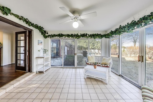 unfurnished sunroom featuring a ceiling fan