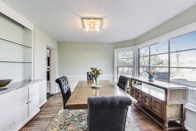 dining room featuring baseboards and dark wood-type flooring