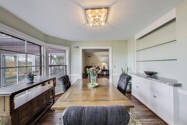 dining area featuring dark wood finished floors and visible vents