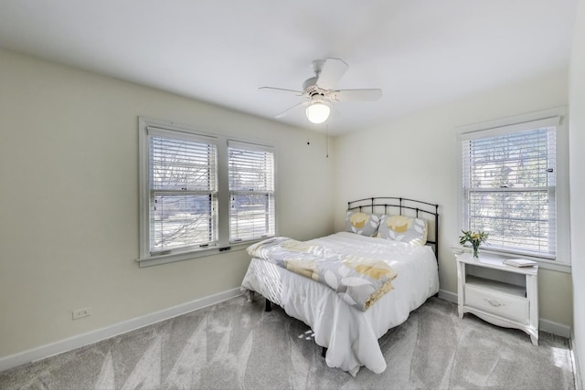 carpeted bedroom with a ceiling fan and baseboards