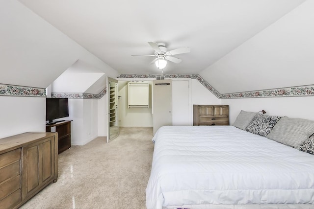 bedroom featuring ceiling fan, vaulted ceiling, baseboards, and light carpet