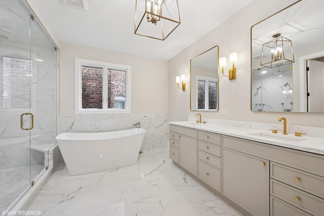 full bath featuring a marble finish shower, double vanity, a freestanding tub, a sink, and marble finish floor