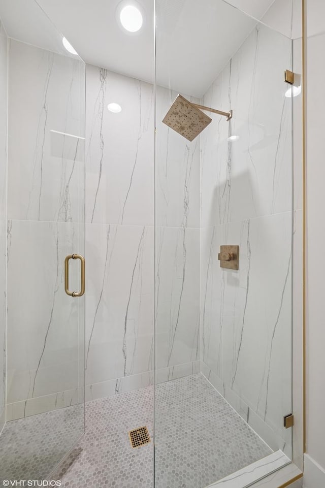 full bathroom with a marble finish shower