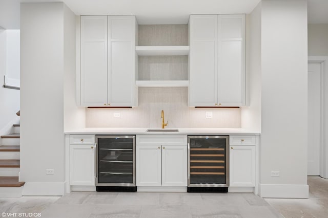 bar with indoor wet bar, stairway, wine cooler, and a sink