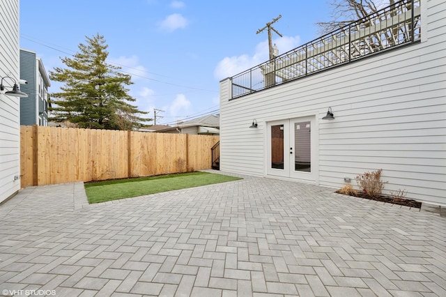 view of patio / terrace featuring french doors and fence