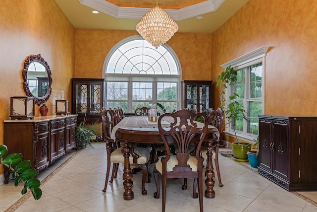 dining room featuring recessed lighting, an inviting chandelier, a towering ceiling, and crown molding