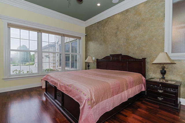 bedroom featuring dark wood finished floors, crown molding, and baseboards