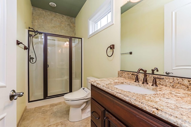 bathroom featuring toilet, a stall shower, and vanity