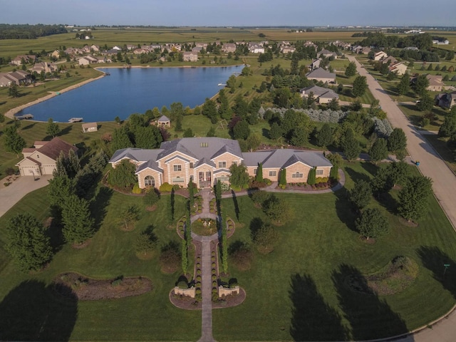 birds eye view of property with a water view and a residential view