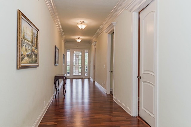 hall featuring crown molding, baseboards, and dark wood-style flooring