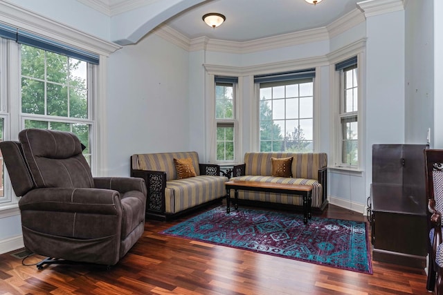 sitting room with wood finished floors, baseboards, and ornamental molding