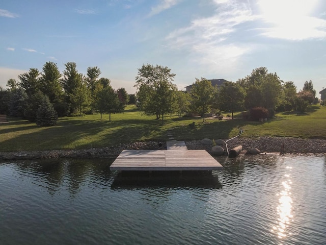 dock area with a yard and a water view