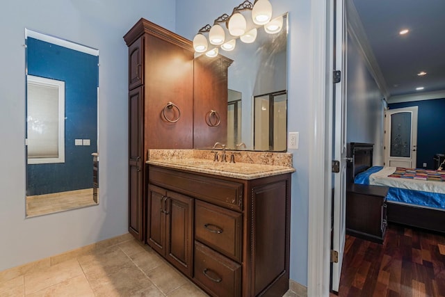 bathroom with connected bathroom, crown molding, recessed lighting, an enclosed shower, and vanity