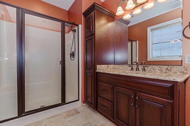 full bath featuring vanity, a notable chandelier, and a stall shower