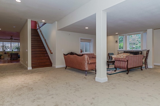 below grade area featuring plenty of natural light, recessed lighting, carpet, baseboards, and stairs