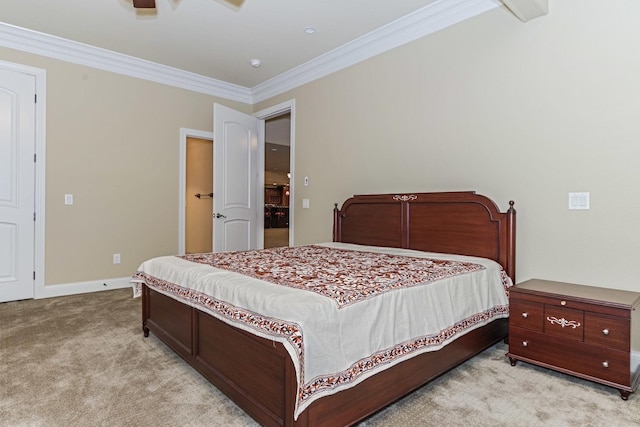 bedroom featuring crown molding, light colored carpet, and baseboards