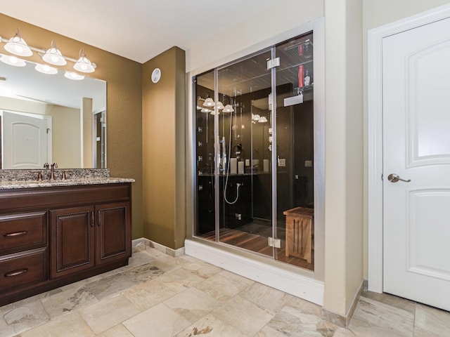 full bath featuring baseboards, a shower stall, and vanity