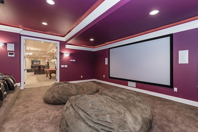 carpeted home theater room with recessed lighting, baseboards, and ornamental molding