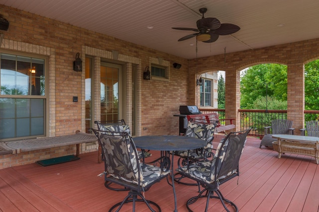 deck featuring outdoor dining space and a ceiling fan