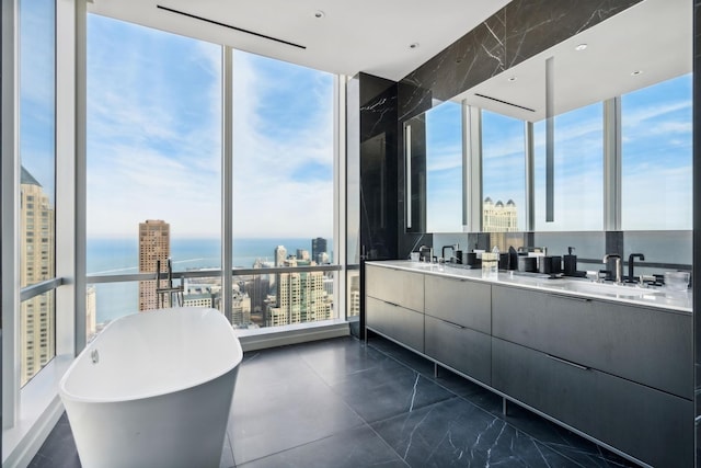 bathroom featuring a sink, a view of city, a soaking tub, and double vanity