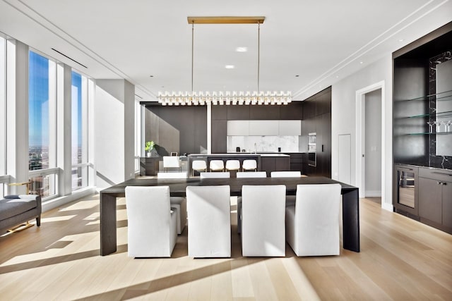 dining area with light wood-style floors and floor to ceiling windows