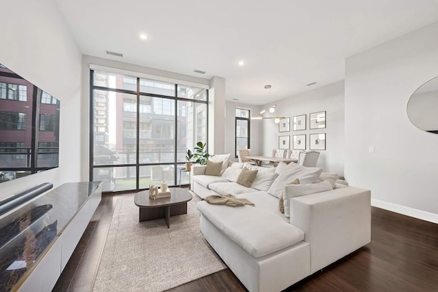 living room with visible vents, recessed lighting, dark wood-style floors, and baseboards