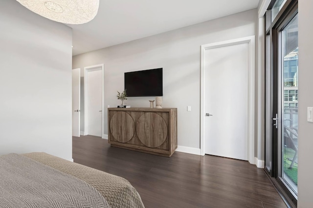 bedroom featuring baseboards and dark wood-style flooring