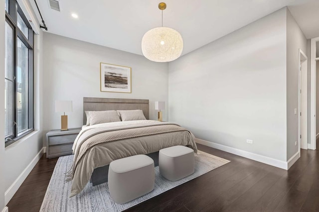 bedroom with dark wood finished floors, recessed lighting, baseboards, and visible vents